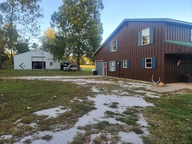 view of property exterior with a garage and an outbuilding