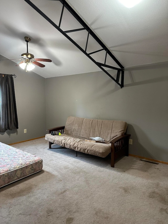 unfurnished bedroom featuring a textured ceiling, ceiling fan, and light colored carpet