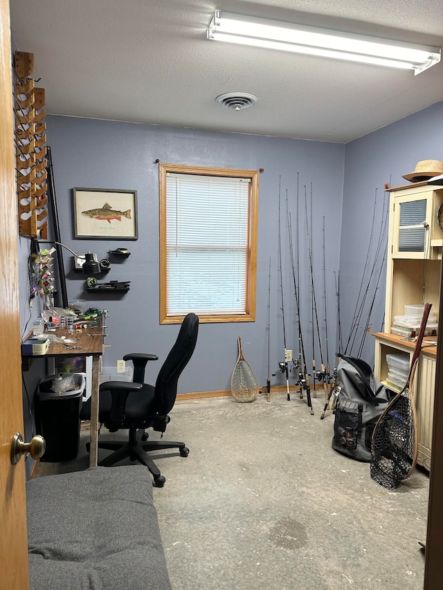 home office with concrete floors and a textured ceiling