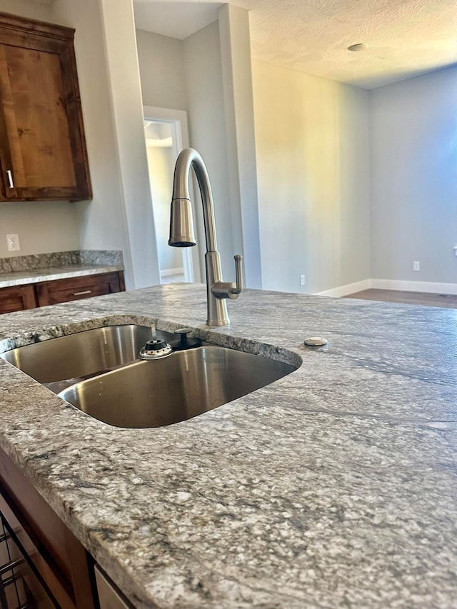 kitchen featuring sink and a textured ceiling