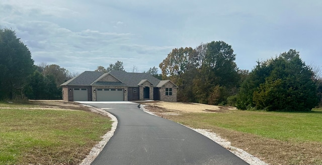 view of front of property with a garage and a front yard