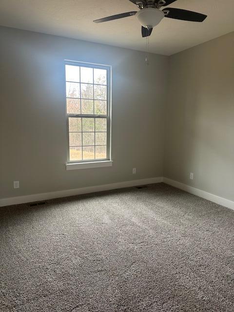 carpeted empty room with ceiling fan