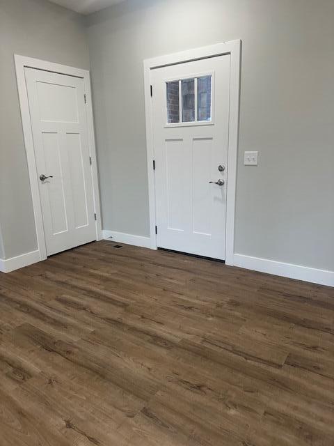 entrance foyer with dark hardwood / wood-style floors