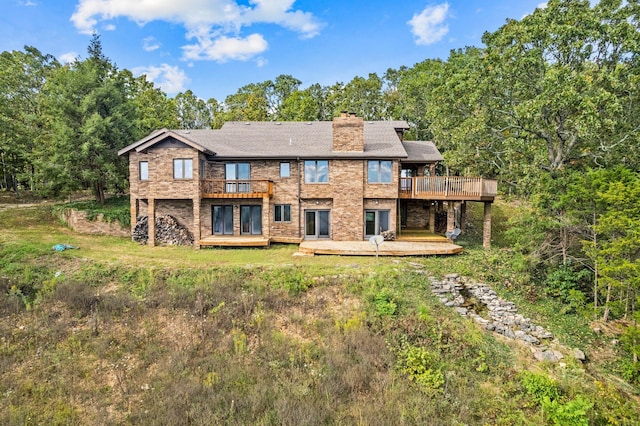 back of property featuring a wooden deck