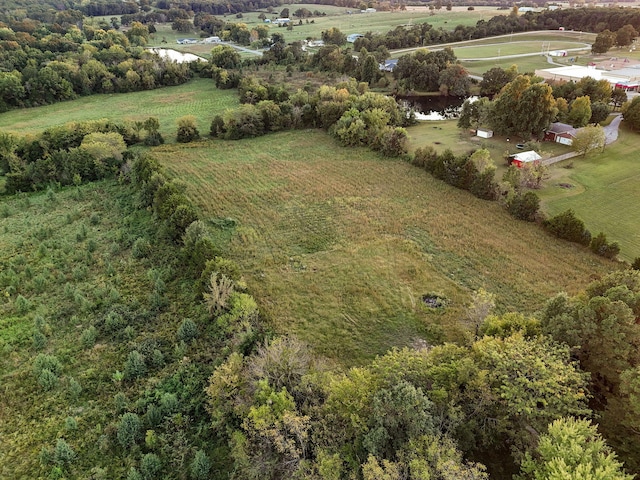 birds eye view of property featuring a rural view and a water view