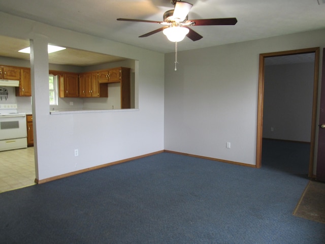 unfurnished living room featuring ceiling fan and light carpet