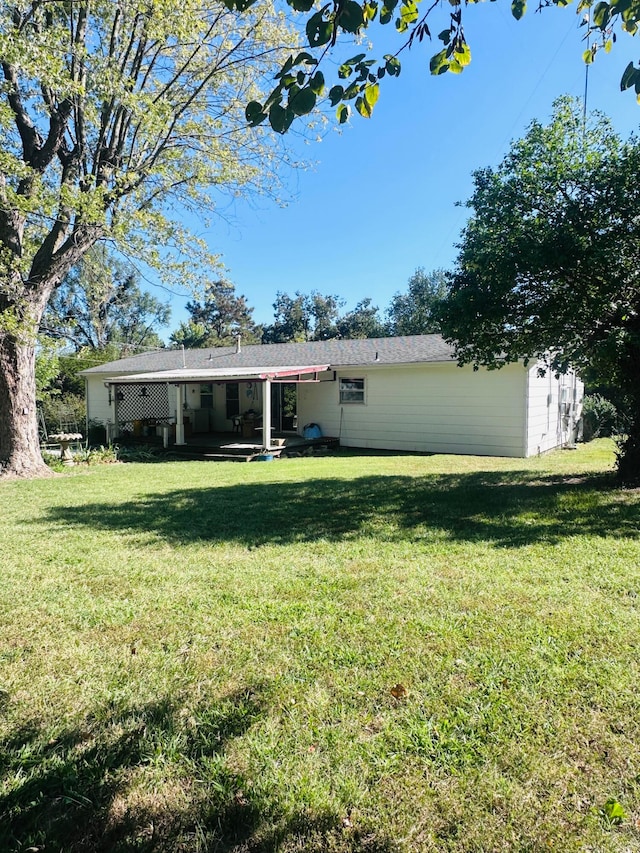 back of house with a lawn