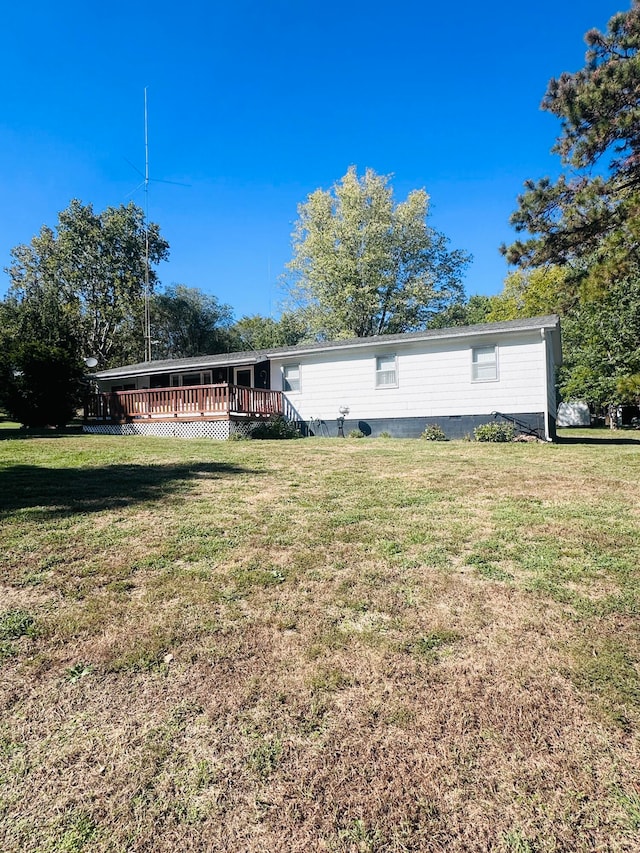 back of house with a yard and a deck