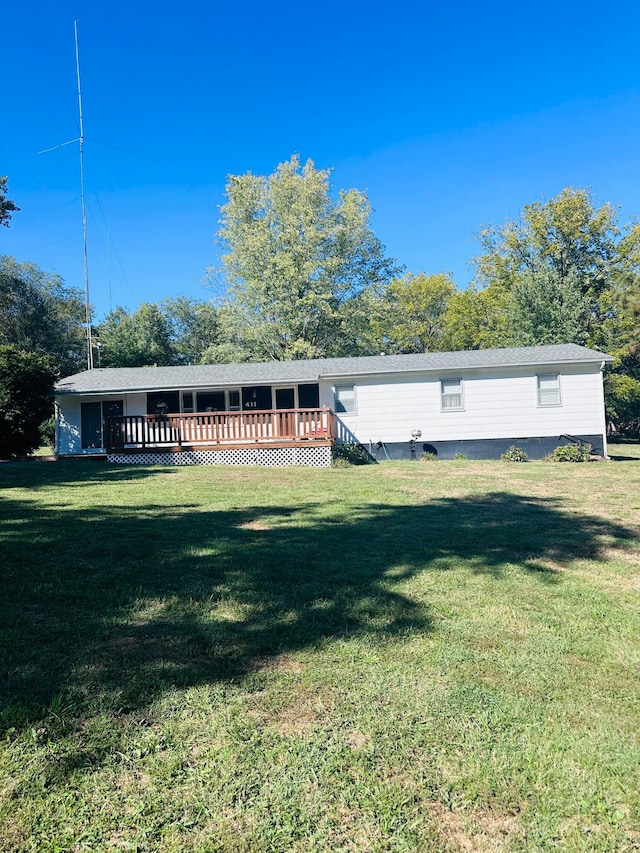 rear view of property featuring a yard and a wooden deck