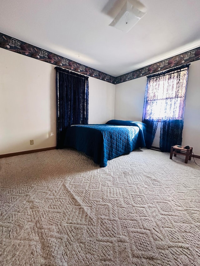 unfurnished bedroom featuring ceiling fan and carpet floors