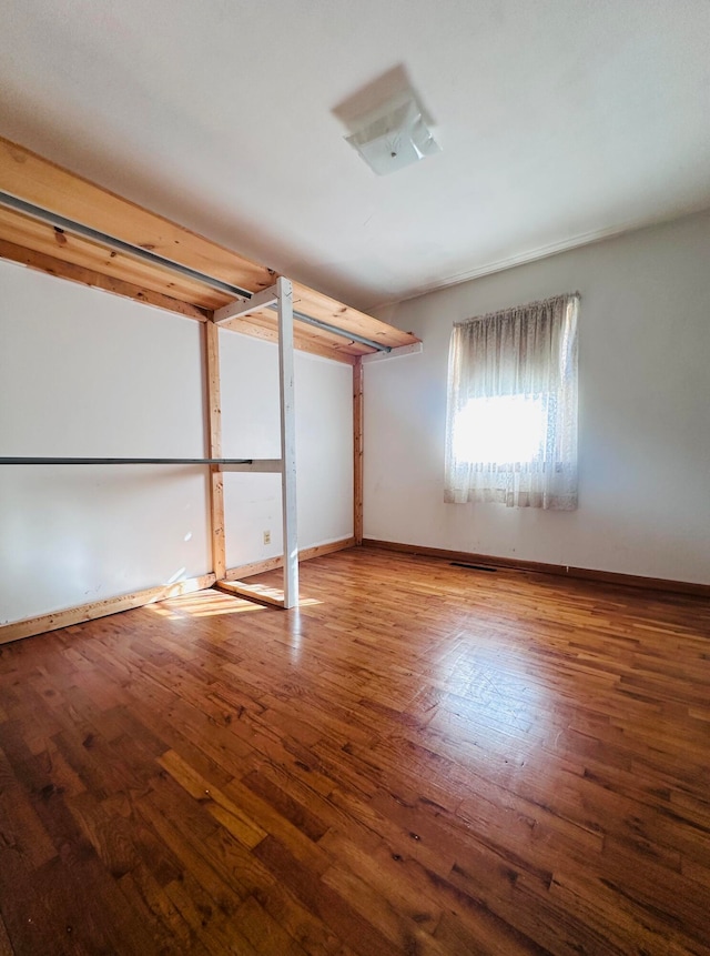 spare room with hardwood / wood-style floors