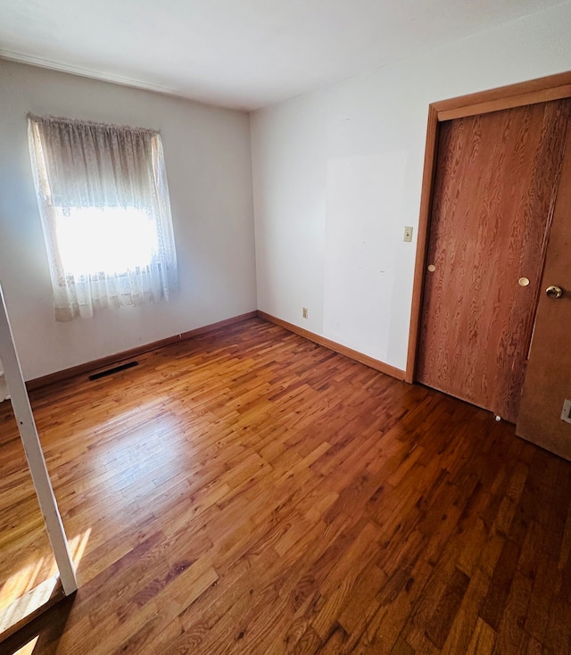 spare room featuring hardwood / wood-style flooring