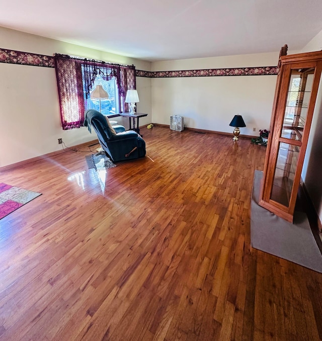 sitting room with wood-type flooring