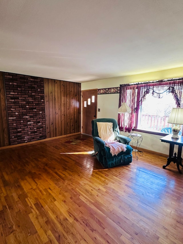 unfurnished room featuring hardwood / wood-style floors and wood walls