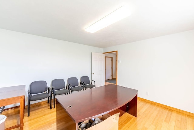 office area featuring baseboards and light wood-style floors