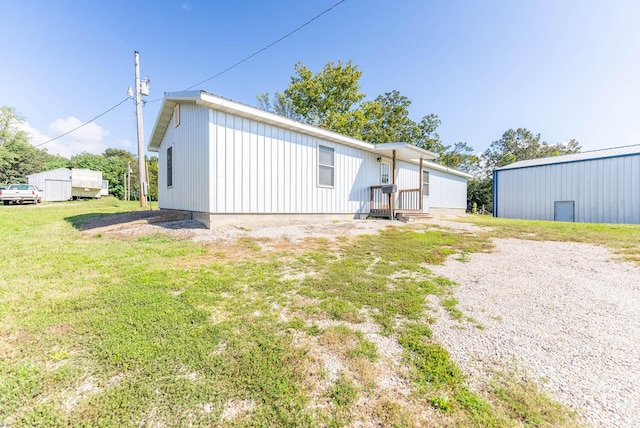 rear view of property with a lawn