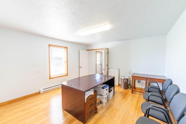 office featuring a baseboard radiator and light wood finished floors