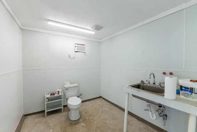 bathroom featuring unfinished concrete floors, toilet, a sink, and a wall mounted AC