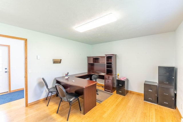 office space featuring baseboards and wood finished floors