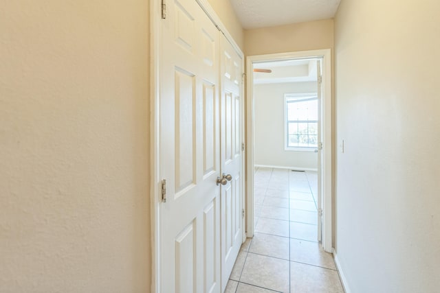 hall with light tile patterned floors