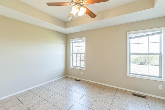 tiled spare room featuring ceiling fan