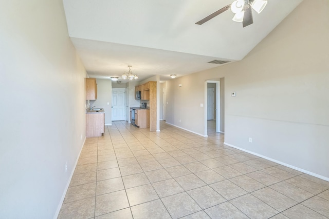 unfurnished living room featuring light tile patterned flooring and ceiling fan with notable chandelier