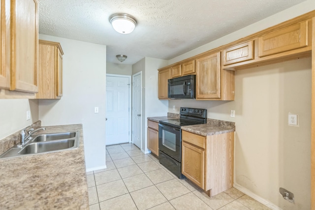 kitchen with black appliances, sink, light tile patterned floors, and a textured ceiling