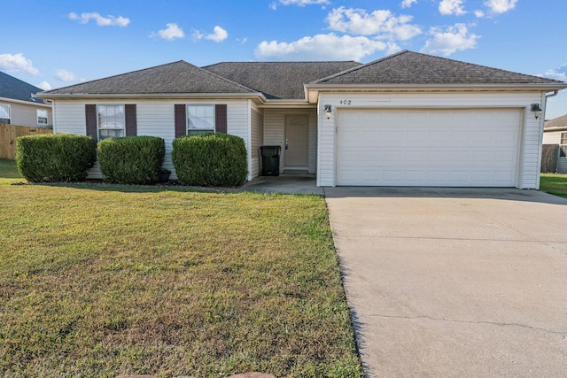 ranch-style home with a garage and a front yard