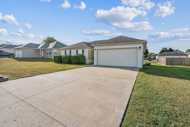 ranch-style home with a garage and a front lawn