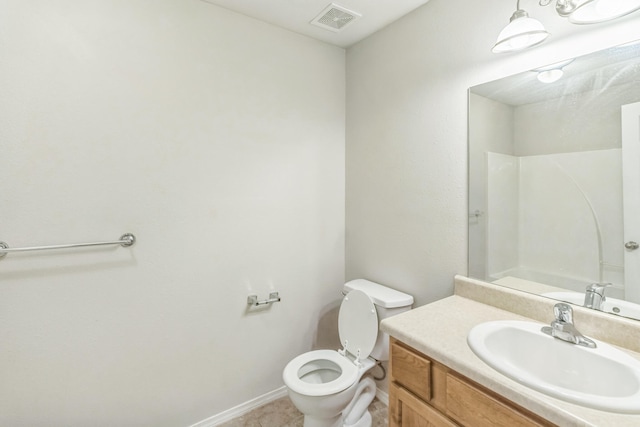 bathroom with vanity, tile patterned flooring, and toilet