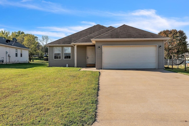 single story home featuring a garage and a front yard