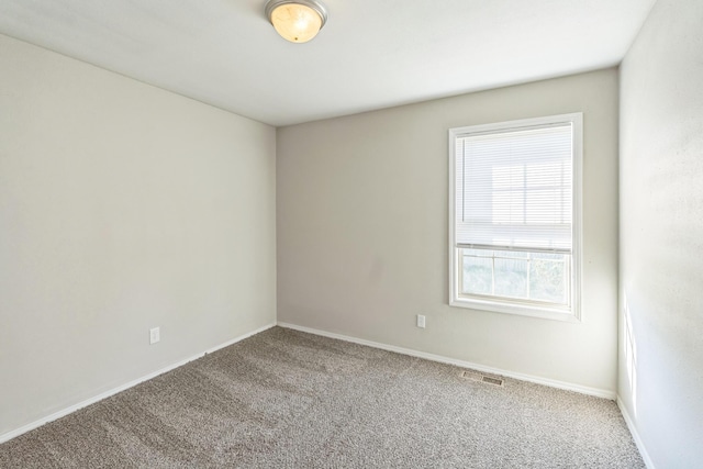 330 W Summit St, Aurora, MO 65605 - carpeted spare room featuring baseboards and visible vents