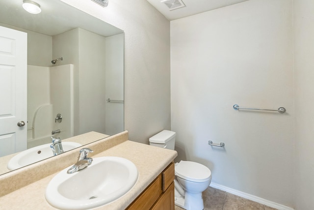 bathroom with vanity, toilet, and tile patterned floors