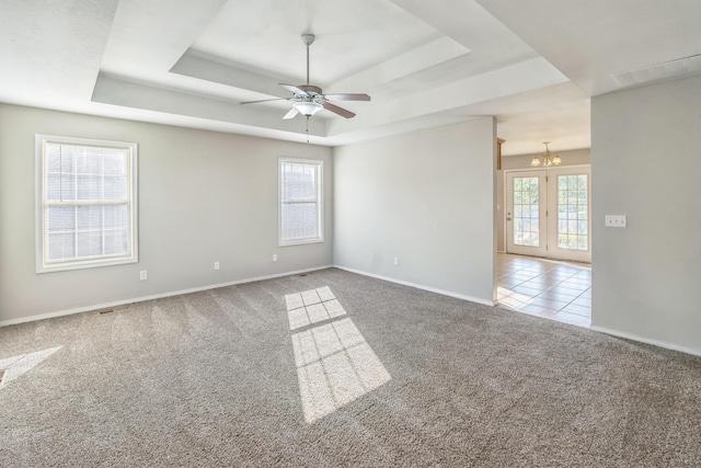 330 W Summit St, Aurora, MO 65605 - carpeted spare room with a healthy amount of sunlight, ceiling fan with notable chandelier, and a raised ceiling