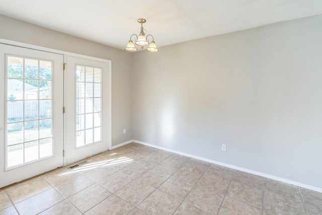 330 W Summit St, Aurora, MO 65605 - empty room featuring baseboards, an inviting chandelier, visible vents, and a wealth of natural light