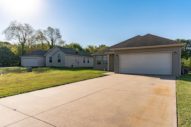 ranch-style house featuring a garage and a front yard