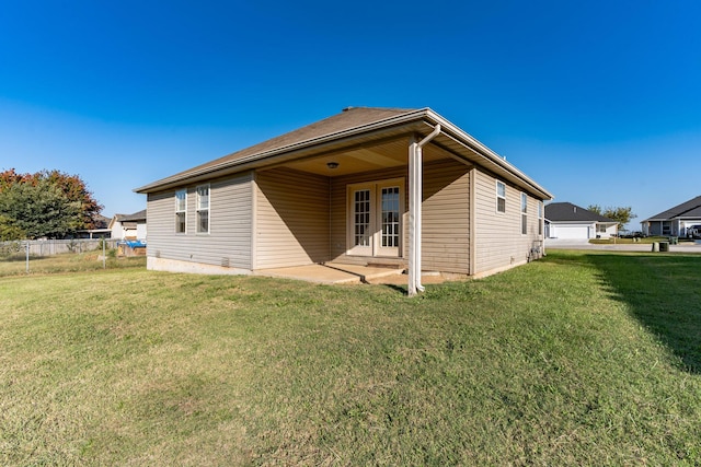 330 W Summit St, Aurora, MO 65605 - back of house with french doors, a patio area, a lawn, and fence