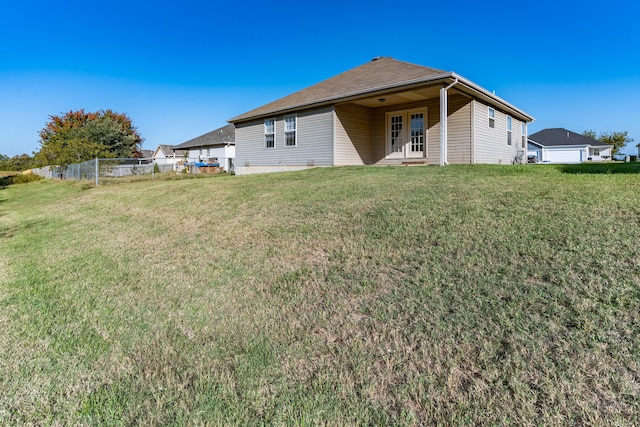 back of house featuring a yard