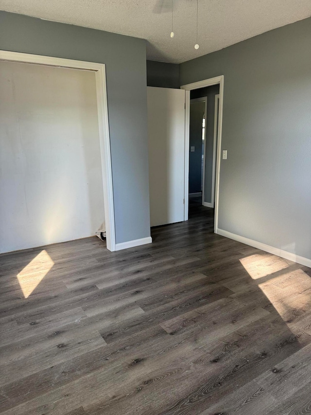 unfurnished bedroom with dark wood-type flooring