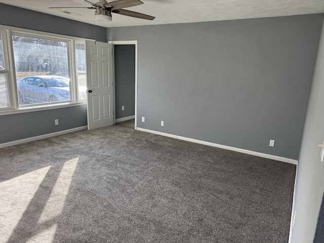 carpeted spare room featuring ceiling fan