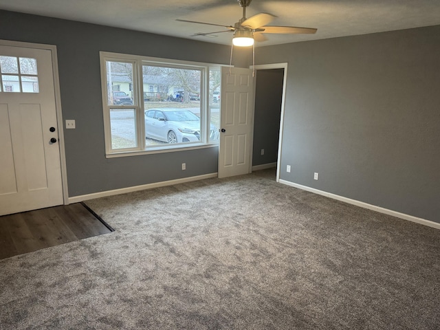 carpeted entrance foyer featuring ceiling fan