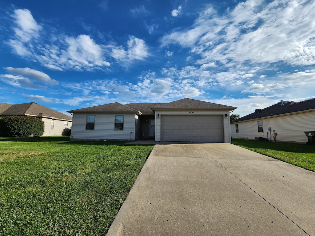 single story home with a front lawn and a garage