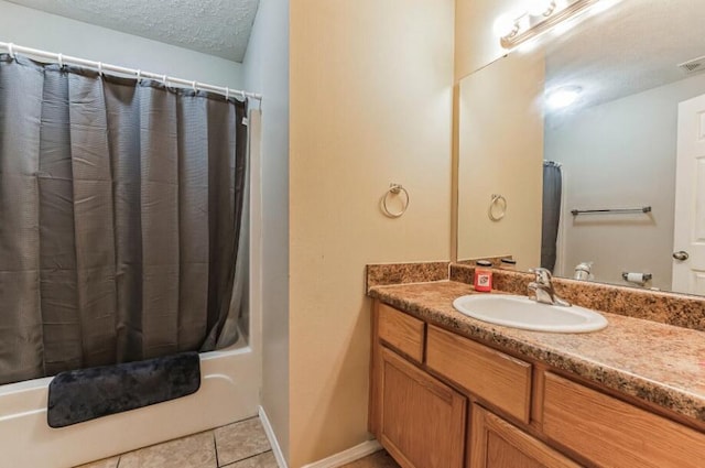 bathroom with vanity, tile patterned flooring, a textured ceiling, and shower / bath combo