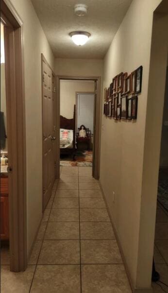 hallway featuring light tile patterned floors