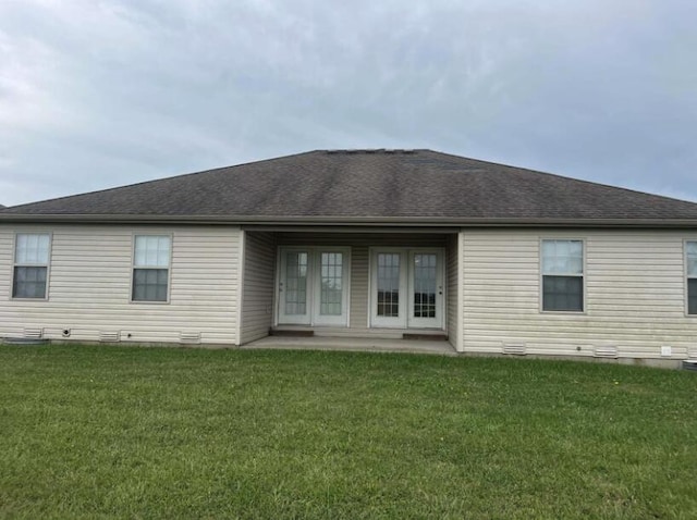 back of property with a patio and a yard