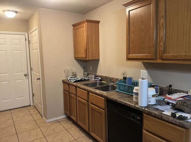 kitchen featuring light tile patterned flooring, black dishwasher, and sink