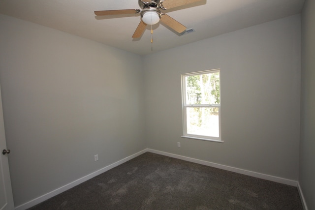 carpeted spare room with ceiling fan