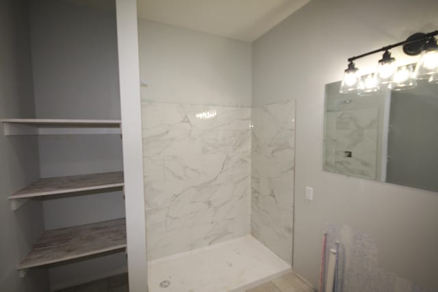 bathroom featuring tile patterned floors and tiled shower