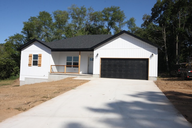 modern inspired farmhouse featuring a garage and a porch