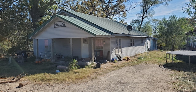 view of front of house with a trampoline and metal roof